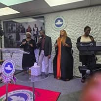 Worship team singing and playing keyboard during a service