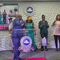 Ministers and worship leaders gathered at the altar during a service