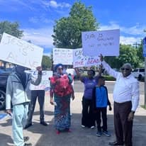 Group holding resurrection-themed signs during Easter outreach
