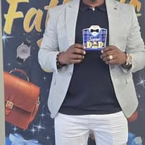 Man in a blazer holding a Father's Day gift mug