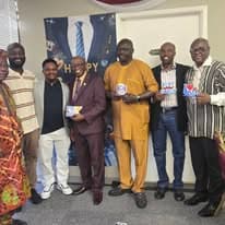 Group of men in traditional attire with Father's Day gifts
